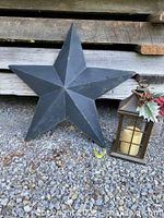 Barn star and lantern on gravel surface