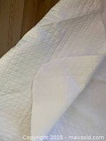 Protector surface and backing folded to show quilted PEVA top and soft underside