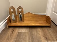 Front view of solid wood shelf with plaques displayed