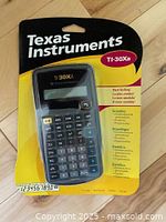Front view of sealed Texas Instruments TI-30Xa calculator in blister pack