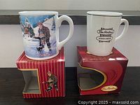 Front view of both mugs on their boxes