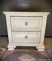 Full view of off-white two-drawer nightstand