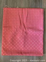 Folded pink upholstery fabric showing full cut