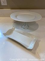 Pedestal cake stand and serving platter together on countertop