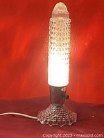 Lit boudoir lamp showcasing the warm light and textured glass shade with hobnail pattern