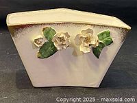 Front view of the ceramic vase showing the floral decoration and shape.