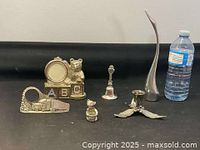 Full lot of silver plate and chrome decorative items displayed against a neutral background showing all pieces together