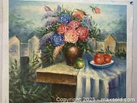 Full view of the still life oil painting showing the flower bouquet in a brown vase, fruits on table, and background with houses.