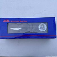 Blue AML branded box with display window showing the steel box car inside with Chandler Arizona lettering and anniversary logo.