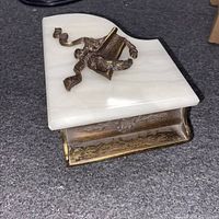 Marble lid of the music box shaped like a grand piano with bronze lyre decoration on top