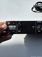 Close-up of front left panel showing model number MX821S, power switch in ON position, and power LED indicator lit.