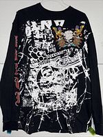 Full front view of the Black Label men's black long sleeve shirt showing layered white graphic artwork with some cracking.