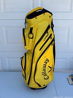Full side view of yellow Callaway ORG 14 golf bag, showing general shape and pocket layout.