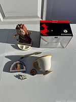 Full lot overview showing clock, bookends box, Chip mug, metal figure, pen, and pins.