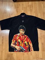 Full view of the black short sleeve men's shirt with large Tony Montana graphic on the front.