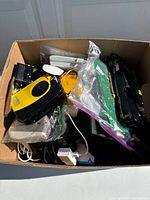 Box filled with assorted electronics and components