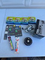 Photo of fishing equipment on table including fishing line, reels, rigs, hooks and lures