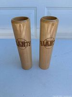 Pair of two wooden dugout mugs shaped like baseball bats with San Francisco Giants logo, shown standing upright.