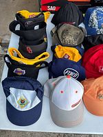 Top down view of hats showing front logos and variety