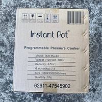 Cardboard box of Instant Pot showing model, voltage, capacity, and handling instructions