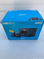 Front view of sealed Logitech Z623 box showing speakers and subwoofer image with 400W power and THX certification.