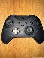 Front view of black Xbox One Elite Series 2 controller showing buttons, analog sticks, and D-pad.