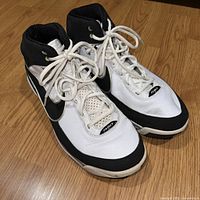Front and top view of Nike Air Max Elite Force black and white high-top sneakers with visible wear and creasing on toe box and sides.