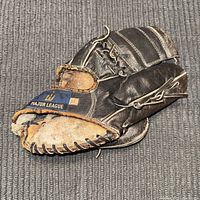 Black Wilson Major League 4665 baseball glove with visible cosmetic wear and rough leather condition.