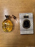 Photo of the vintage Eau De Guerlain perfume bottle with spray nozzle and original packaging box on a wooden surface.