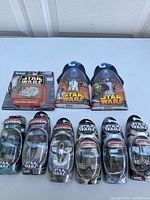 Overview of all Star Wars toys in packaging showing die-cast vehicles and action figures.