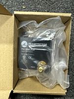 Transtector TSJ GBE PoE surge protector sealed in plastic inside an open cardboard packaging.
