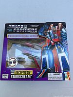Front view of sealed box with Transformers Decepticon Starscream figure displayed inside.