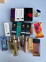 Full lot of vintage fragrance bottles and boxes photographed on neutral surface.