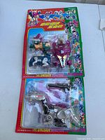 Two vintage Transformers toys from The Dinosaur Monsters series in blister packs with colorful packaging showing wear.