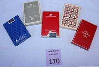 All five decks displayed with identifiable airline brands, including two sealed Continental decks marked with original stickers; shows color and condition of each deck.
