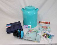 Wide shot showing entire lot of items including lunch bag, headphones, beverage dispenser, and party favors