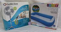Photo of both items in their original packaging - Comfort Zone oscillating pedestal fan box and Intex Family Pool box