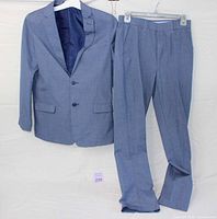 Full view of Nautica chambray suit jacket and trousers size 18 hung against a white background