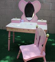 Full frontal view of the child's vanity with butterfly mirror and matching chair.