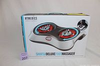 Front of the box showing the product image of the foot massager with dual rotating massage heads.