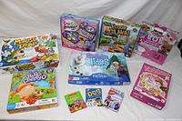 Lot includes two Mouse Trap board games, Vampirina Spin Go Round game, Frozen Surprise Slides game, The Floor is Lava game, LOL Surprise Eye Spy game, HiHo Cherry-O board game, Apples to Apples, Dos, and Frozen Uno card games and a Princess Yahtzee game.