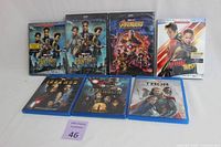 Photo showing all 8 Marvel Blu-ray and DVD titles laid out on a flat surface.