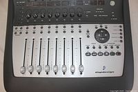 Front overview of the Digidesign Digi 002 ProTools mixer showing channel faders, mute/solo buttons, and rotary controls.