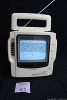 Front view of Sony Mega Watchman FD-525 portable TV showing screen with static and control buttons.
