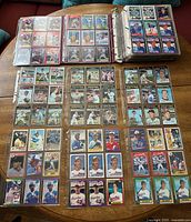 Binder open showing baseball cards of rookies, hall of famers and vintage players