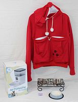 Red pet owner sweatshirt with front pouch and hood with ears displayed on hanger.