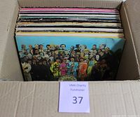 Box of vinyl LPs in cardboard box showing album spines