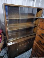 Full front view of stacked wood and glass china cabinet