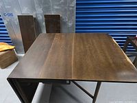 Top view table assembled with leaves leaning against wall