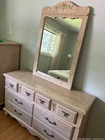 Front angle view of six drawer solid wood dresser with matching mirror on top showing overall condition and style